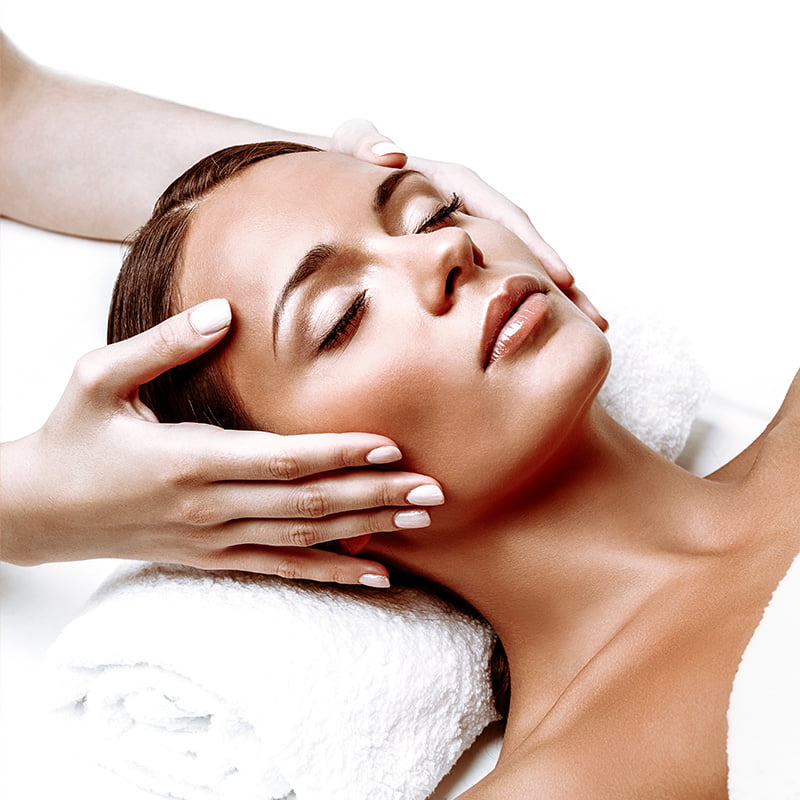 tanned woman getting a facial