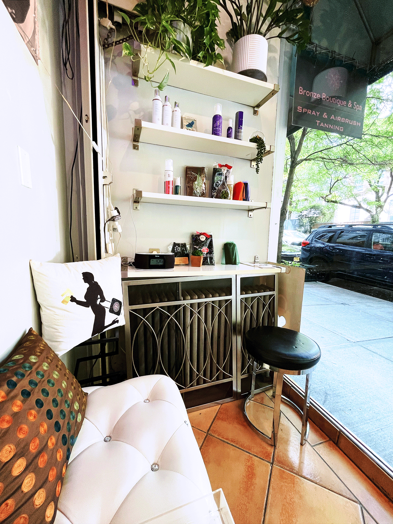 Warm lit room with dark curtains with spray tanning airbrush equipment and and protective clean surfaces.